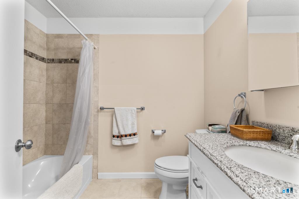 3 MacIntosh Lane, Unit 3 Ansonia, CT 06401 - Photo 27 of 34 a bathroom with a granite countertop sink toilet and shower