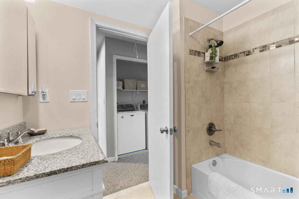 3 MacIntosh Lane, Unit 3 Ansonia, CT 06401 - Photo 28 of 34 a bathroom with a granite countertop tub sink and mirror