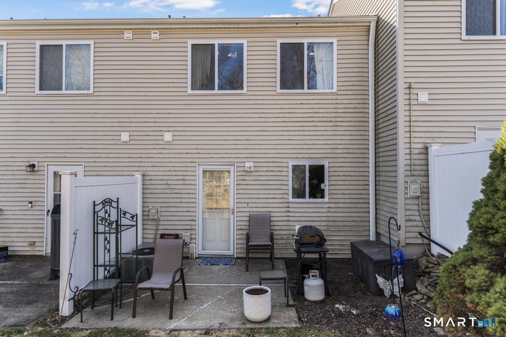3 MacIntosh Lane, Unit 3 Ansonia, CT 06401 - Photo 33 of 34 a side view of a house with patio