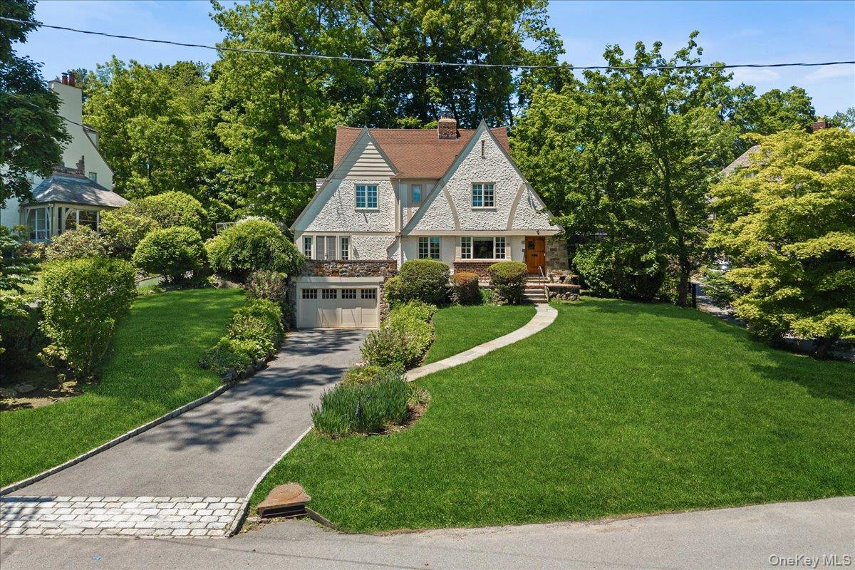 311 Lyncroft Road New Rochelle, NY 10804 - Photo 1 of 39 a view of a house with a yard and potted plants