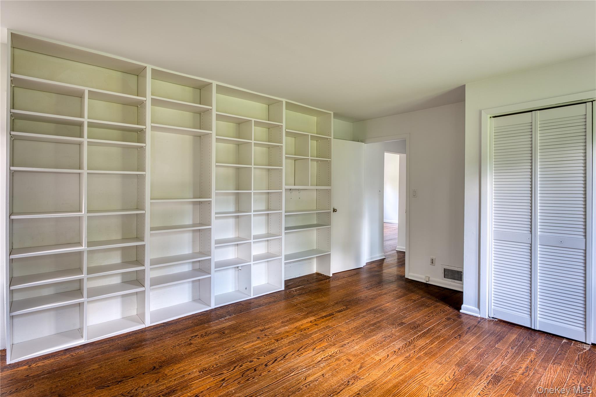 61 Indian Brook Road Garrison, NY 10524 - Photo 18 of 23 a view of an empty room with wooden floor and a window