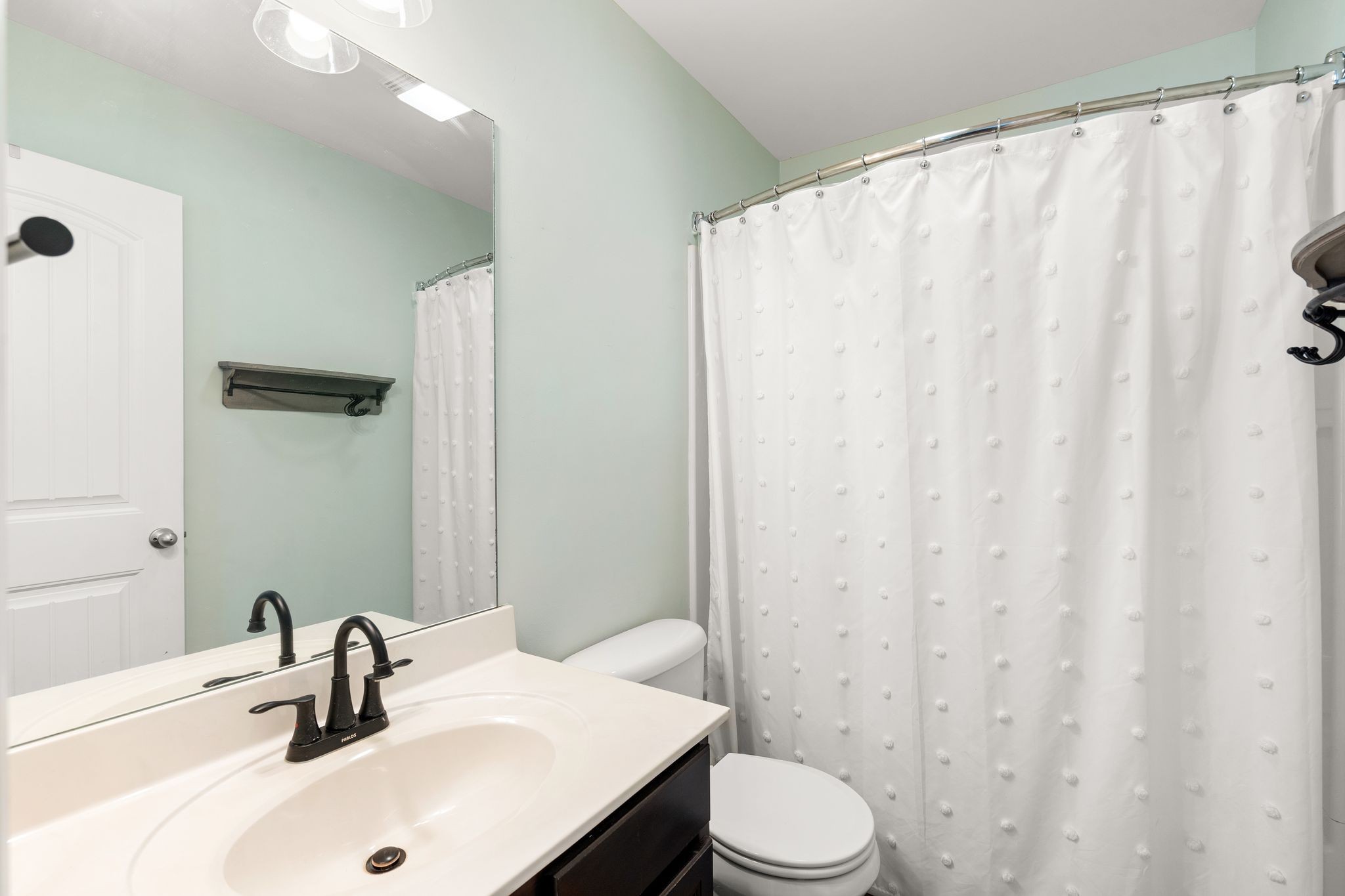 1908 Boxelder Alley Hermitage, TN 37076 - Photo 23 of 31 a bathroom with a sink a toilet and shower curtain