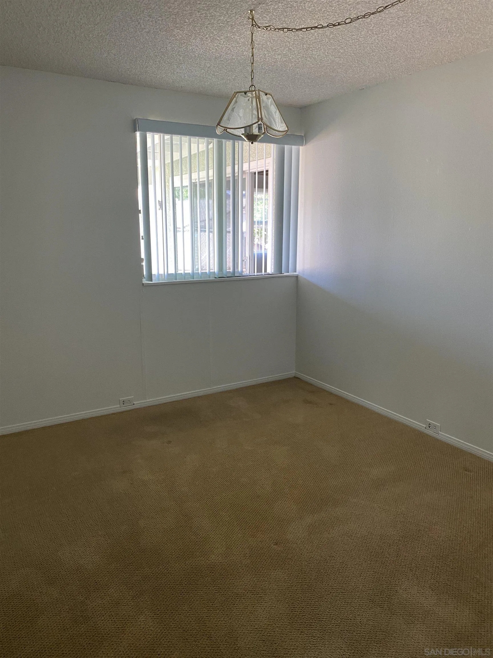 748 Ellen Lane El Cajon, CA 92019 - Photo 13 of 15 an empty room with a window and a chandelier