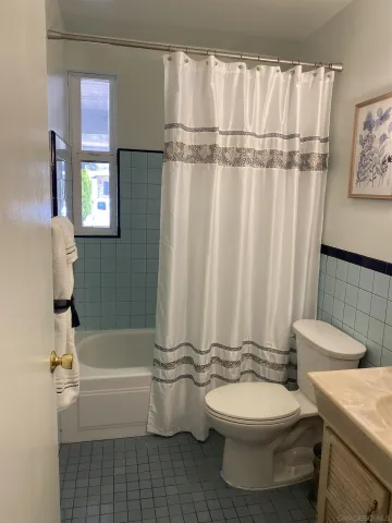 a bathroom with a toilet a sink and bathtub