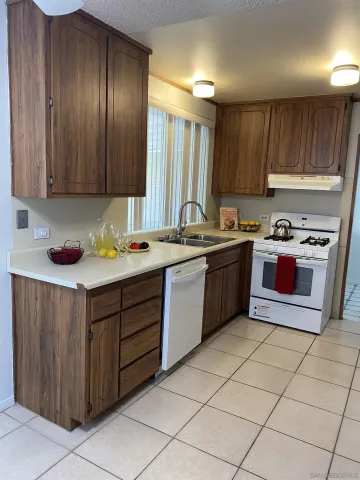 a kitchen with a cabinets sink and white appliances
