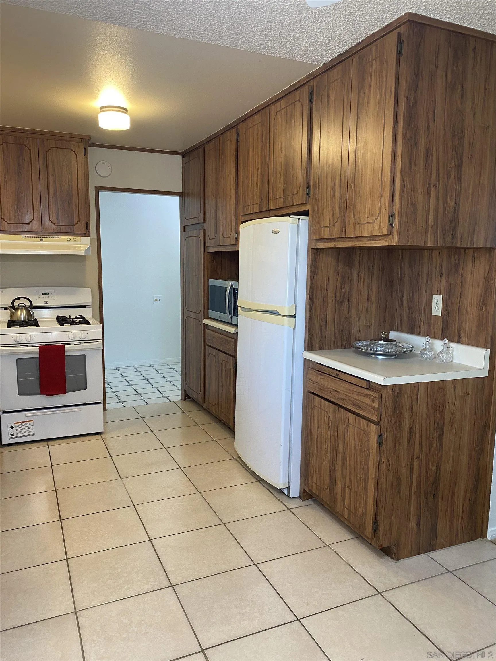 748 Ellen Lane El Cajon, CA 92019 - Photo 5 of 15 a kitchen with a refrigerator sink and cabinets