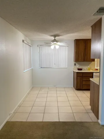 a kitchen with granite countertop a stove a sink and a refrigerator