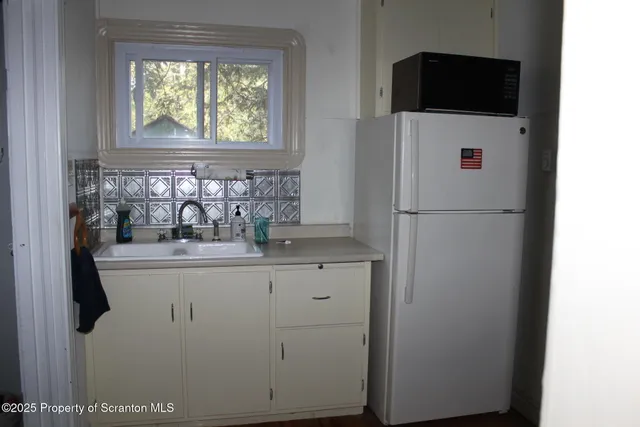 a kitchen with a refrigerator and a window
