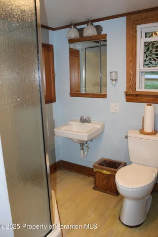 a bathroom with a toilet a sink and mirror