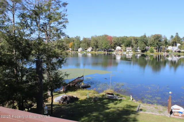 a view of a lake in between two of trees