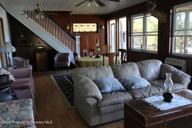 a living room with furniture and a floor to ceiling window