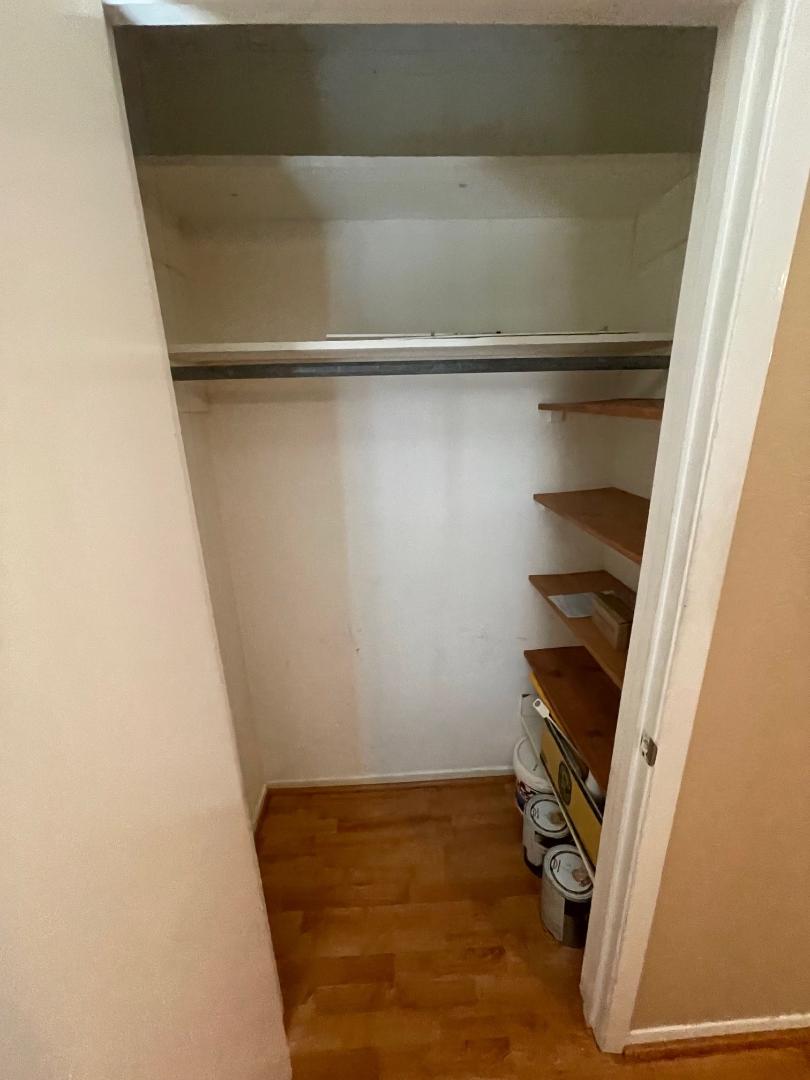 910 Duncan Lane, Unit 44 Austin, TX 78705 - Photo 13 of 15 Organized shelving and a hanging rod make this a functional storage space.