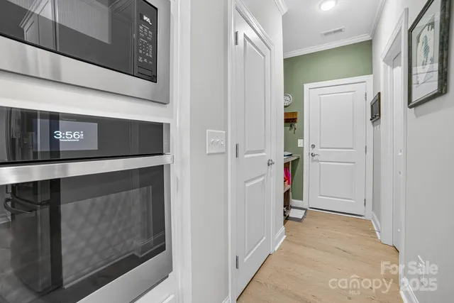 a large kitchen with kitchen island a stove a sink dishwasher and a dining table with the bookshelf