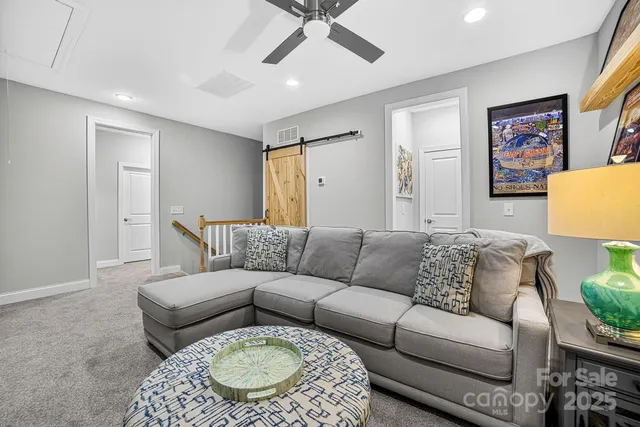 a bedroom with a bed window and couch