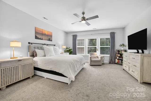 a bedroom with a bed and ceiling fan