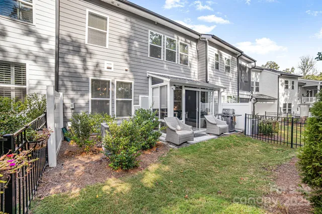 a view of a house with backyard and sitting area