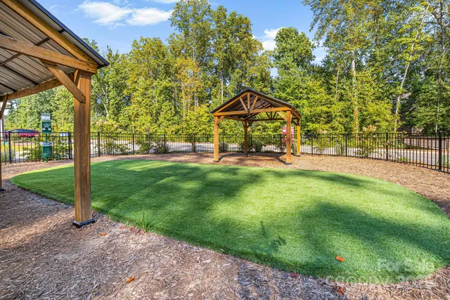 a view of a patio with a table and chairs under an umbrella