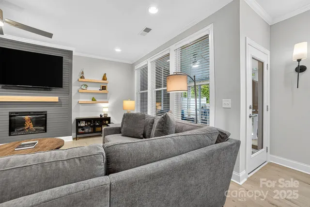 a living room with fireplace furniture and a wooden floor