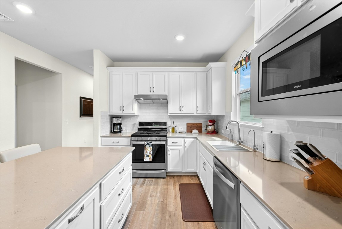 104 Coachsmith Street Georgetown, TX 78633 - Photo 11 of 38 a kitchen with a sink stove and microwave