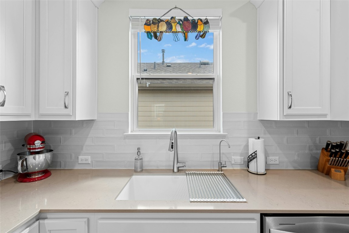 104 Coachsmith Street Georgetown, TX 78633 - Photo 12 of 38 a kitchen with a sink and cabinets