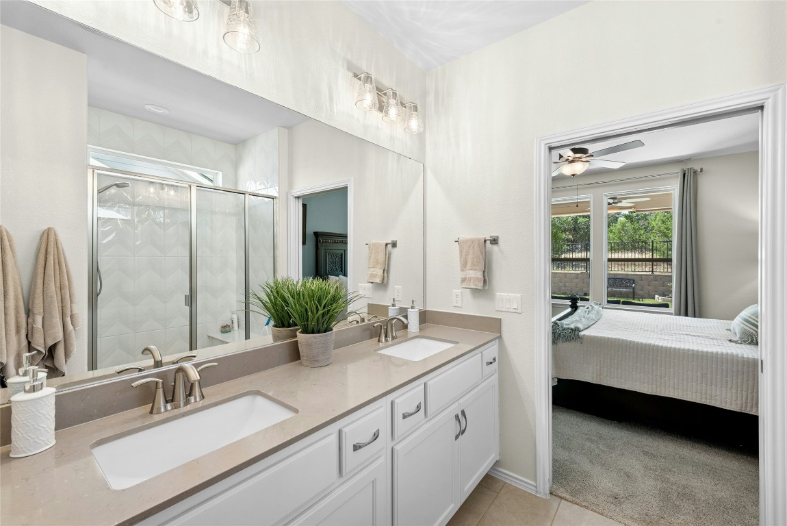 104 Coachsmith Street Georgetown, TX 78633 - Photo 19 of 38 a bathroom with a double vanity sink and mirror