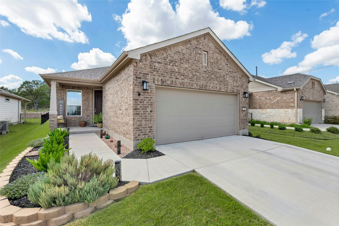 104 Coachsmith Street Georgetown, TX 78633 - Photo 2 of 38 a front view of a house with a garden and trees