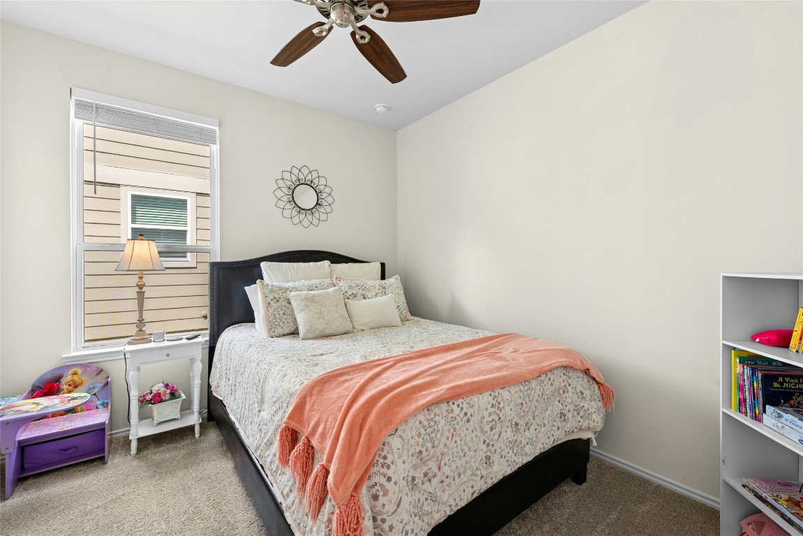 104 Coachsmith Street Georgetown, TX 78633 - Photo 21 of 38 a bedroom with a bed and a book shelf
