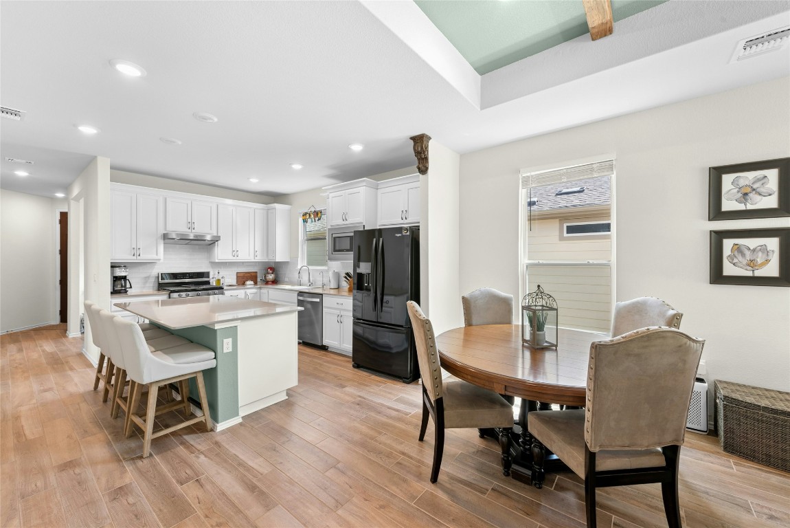 104 Coachsmith Street Georgetown, TX 78633 - Photo 9 of 38 a view of a dining room with furniture a rug and wooden floor
