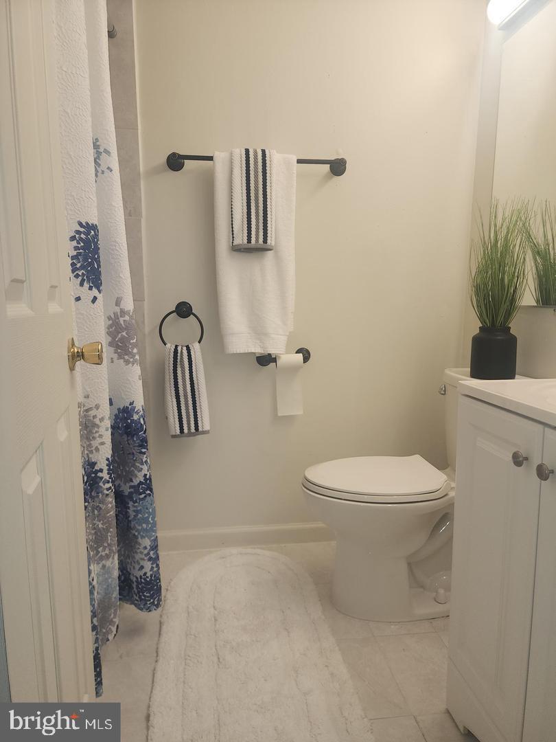 1270 Palmer Road, Unit 92 Fort Washington, MD 20744 - Photo 12 of 24 a white toilet sitting next to a bathroom sink