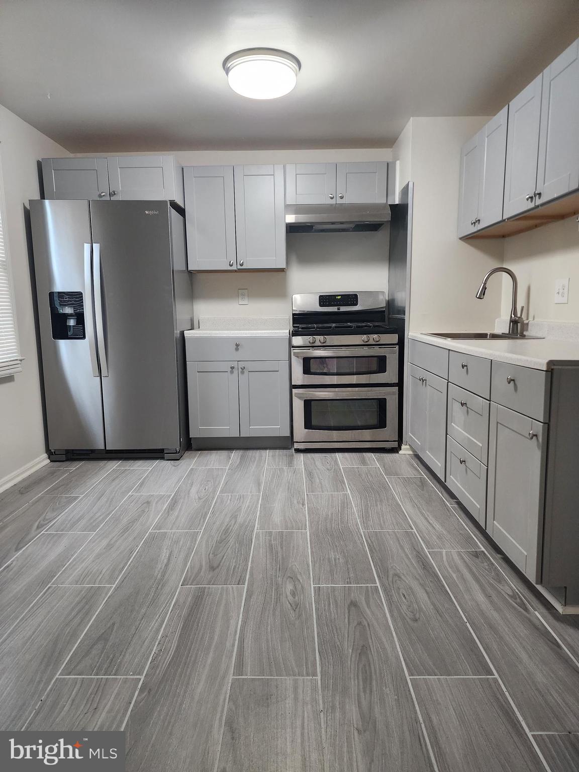 1270 Palmer Road, Unit 92 Fort Washington, MD 20744 - Photo 2 of 24 a kitchen with a refrigerator and a stove top oven