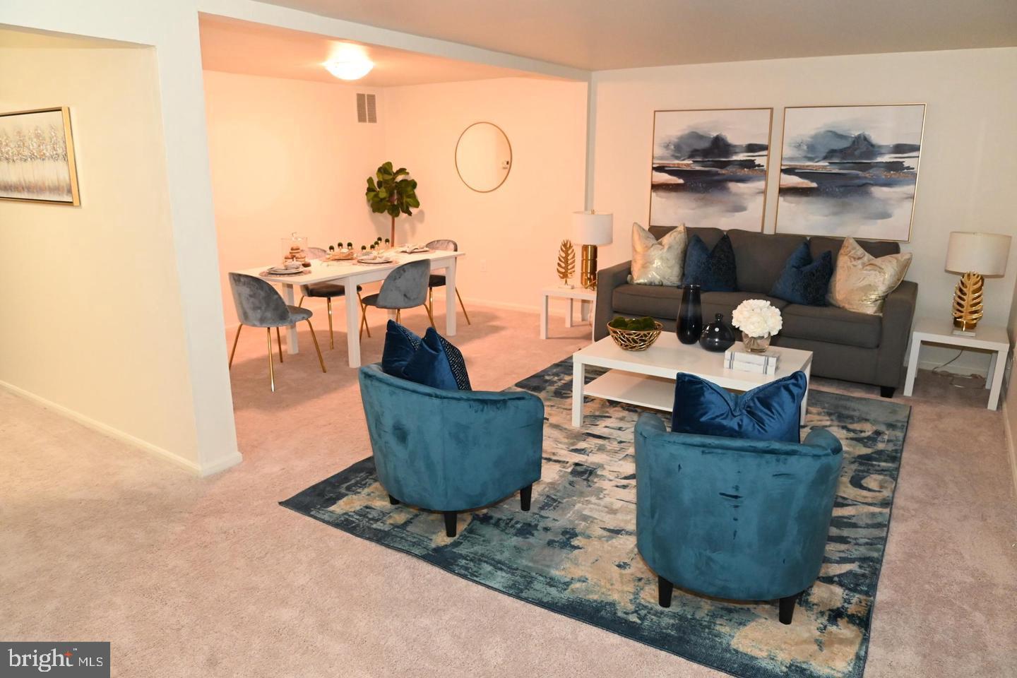 1270 Palmer Road, Unit 92 Fort Washington, MD 20744 - Photo 7 of 24 a living room with couches and kitchen view with wooden floor