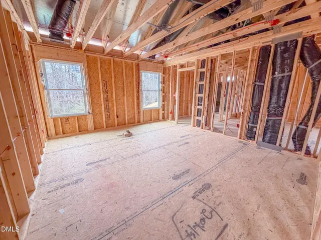 a view of a hallway with wooden floor and doors