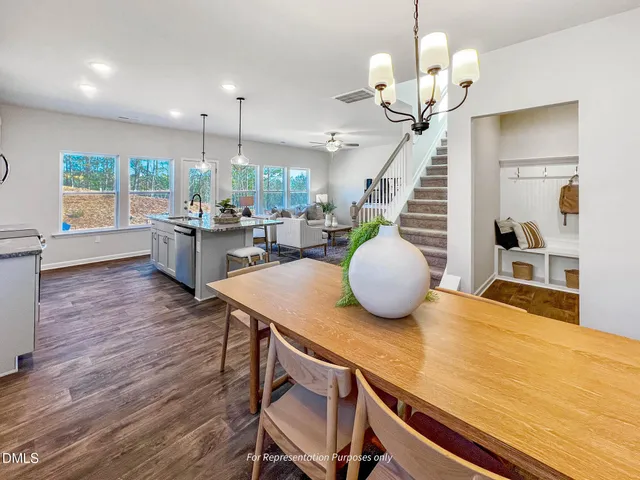 a kitchen with granite countertop a sink a stove and wooden floor