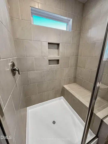 a bedroom with a bed and a night stand