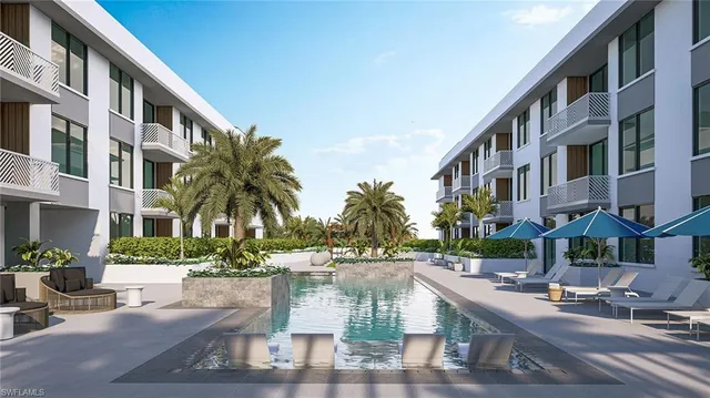 a view of multiple houses with yard and green space