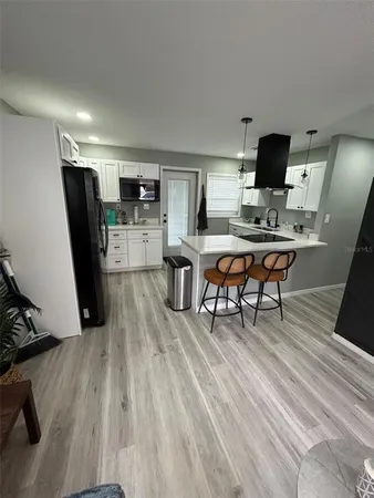 a kitchen with stainless steel appliances white cabinets and a sink