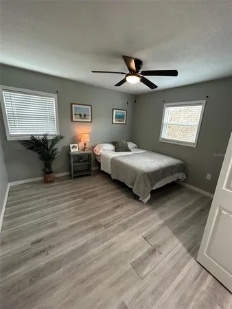 a bedroom with two beds and a chandelier