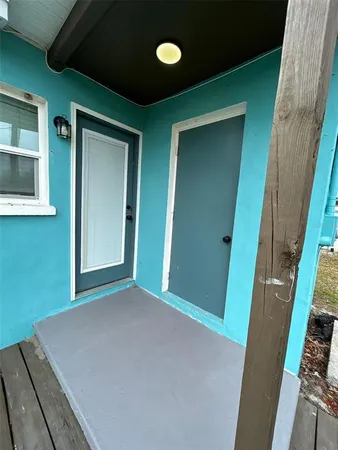 a view of a hallway to a livingroom and a hall with wooden floor