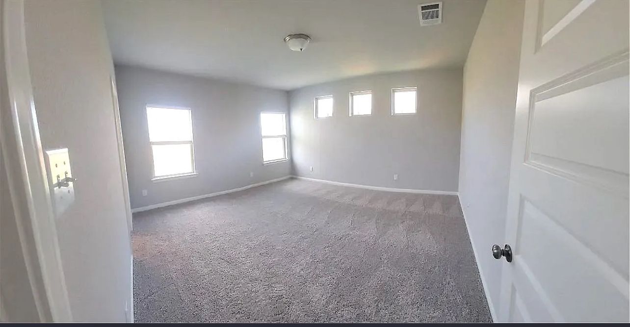489 Unforgiven Lane Jarrell, TX 76537 - Photo 6 of 9 an empty room with windows and closet