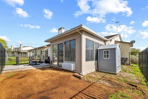 a view of a house with a big yard plants and large trees