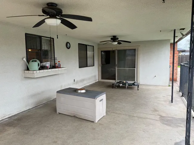 a view of a swimming pool with a table and chairs in the patio