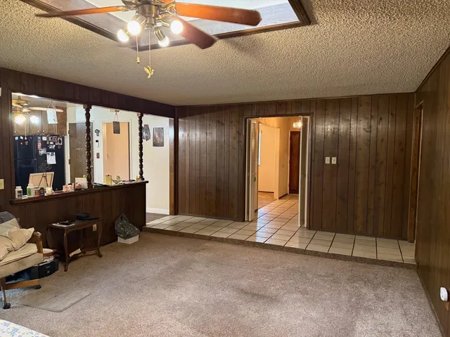 a kitchen with stainless steel appliances granite countertop a sink a stove and a wooden floors