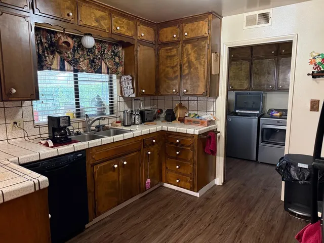 a kitchen with a refrigerator and a stove top oven