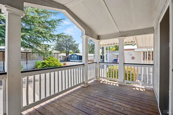 a view of a balcony with wooden floor