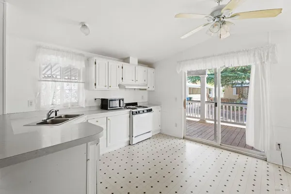a kitchen with a refrigerator a stove a sink and a window