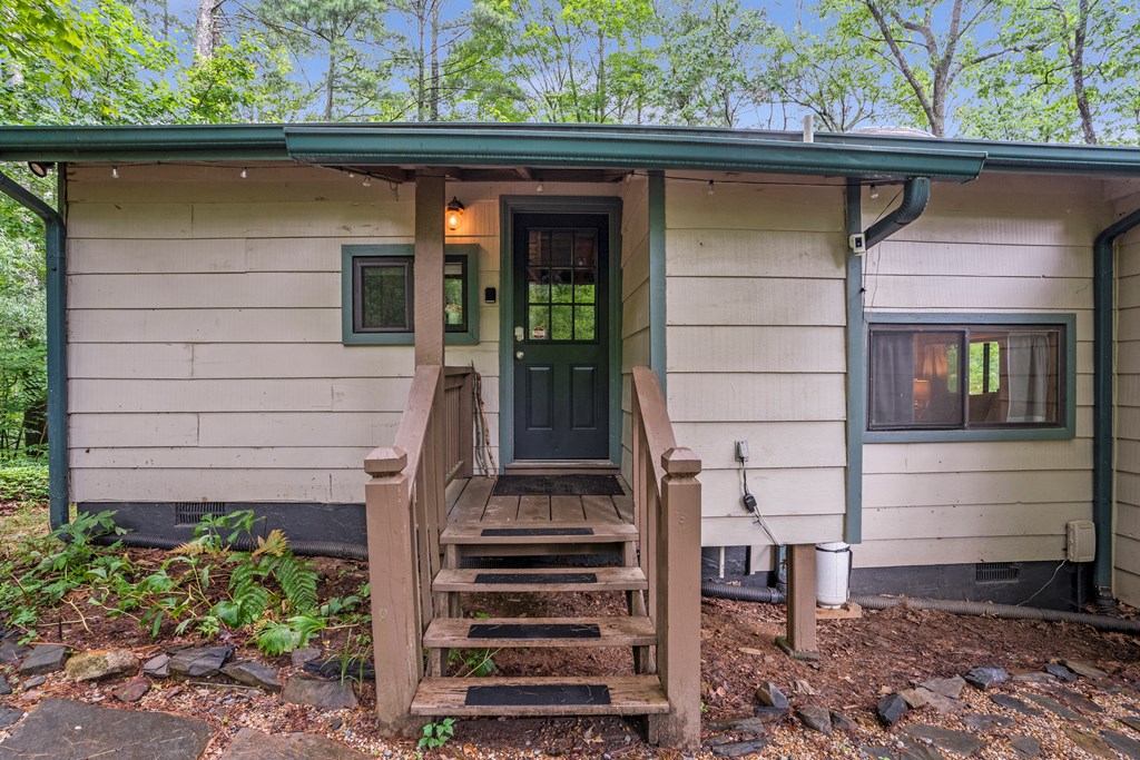 87 Rustic Ridge Road Blue Ridge, GA 30513 - Photo 11 of 23 a front view of a house with a garden