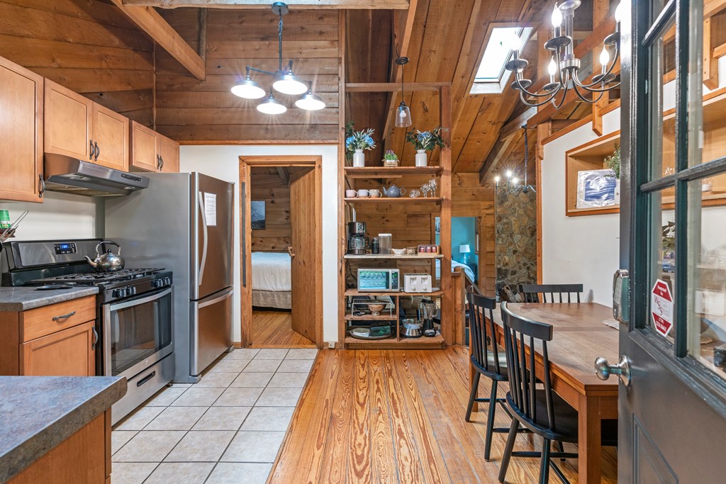 87 Rustic Ridge Road Blue Ridge, GA 30513 - Photo 13 of 23 a kitchen with stainless steel appliances granite countertop a stove and a refrigerator