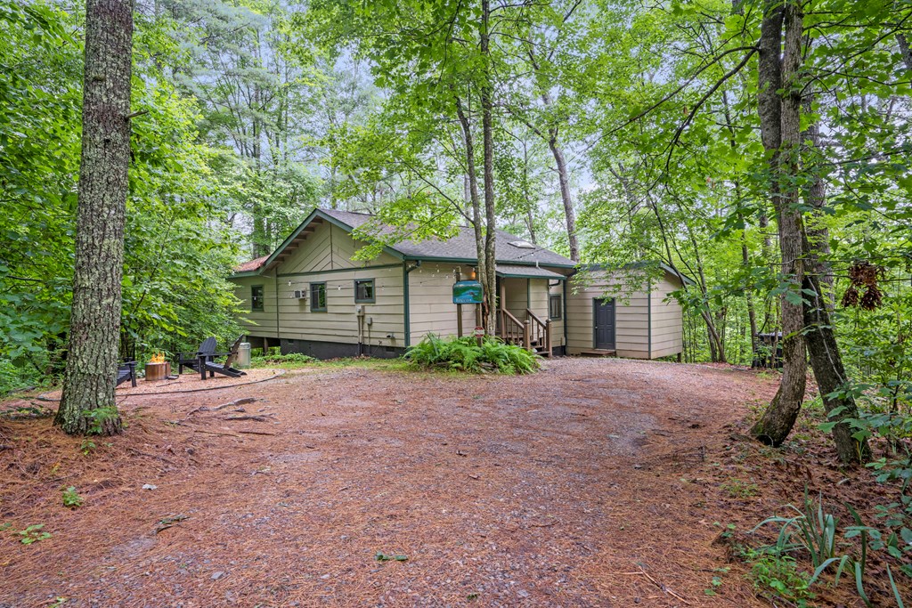 87 Rustic Ridge Road Blue Ridge, GA 30513 - Photo 7 of 23 a front view of a house with a garden and tree