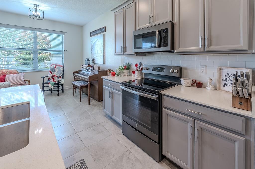 9224 Southwest 60th Ct Road Ocala, FL 34476 - Photo 12 of 55 a kitchen with stainless steel appliances granite countertop a stove a sink and a microwave