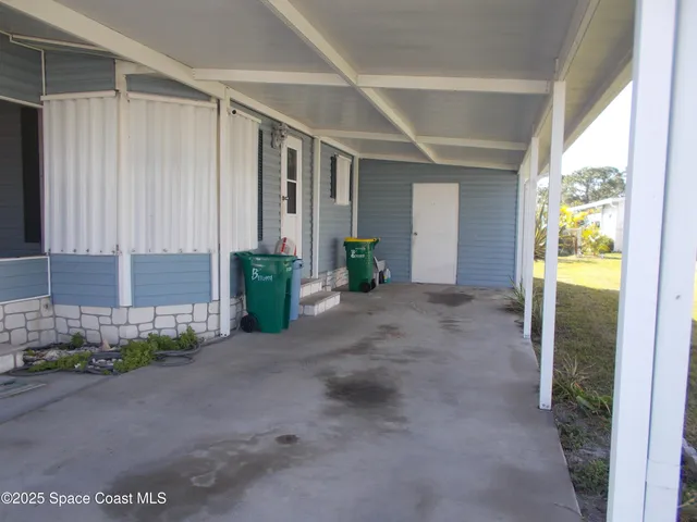 a view of a house with a backyard and garage